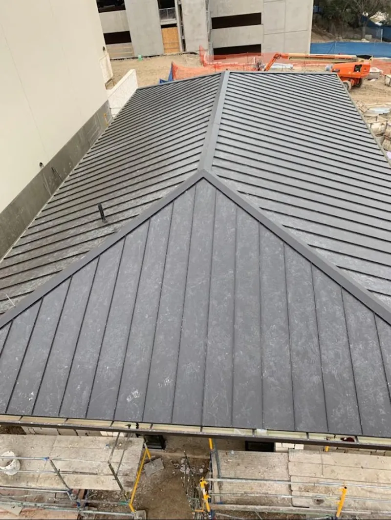 Commercial metal roof construction with crane equipment in Arcadia